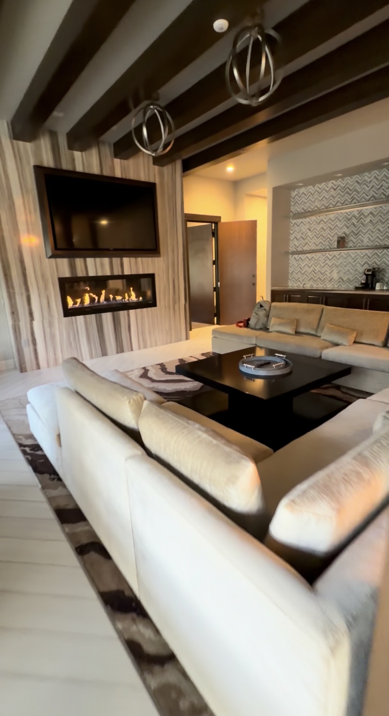 Monarch two-bedroom penthouse living and dining area with white seating and green dining chairs.